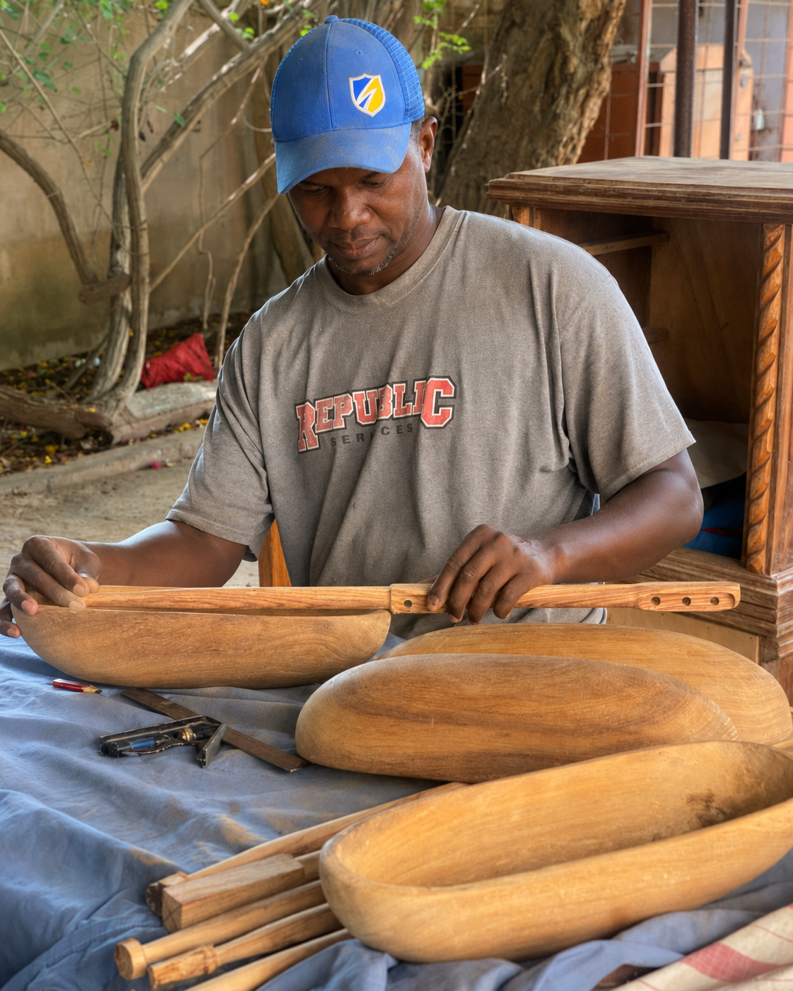 Abdoulaye Traoré Diop seated with a finished xalam in Dakar